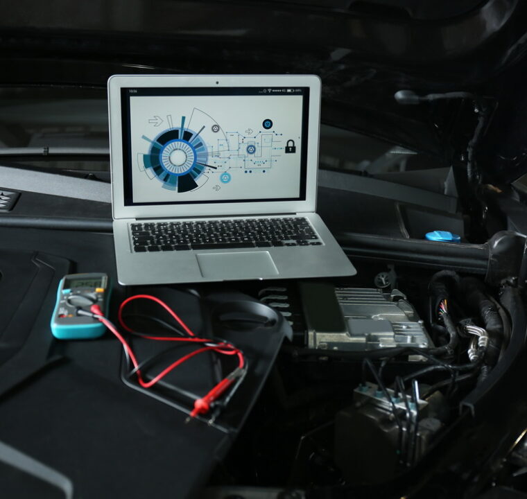 Laptop with diagram on auto engine. Modern car diagnostic